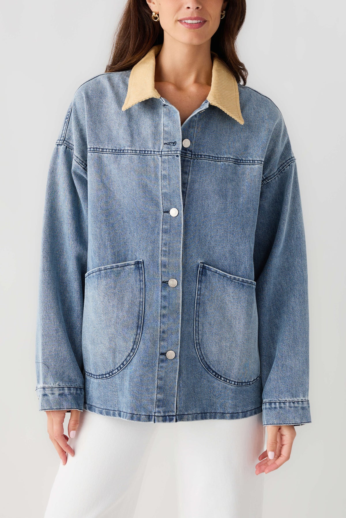 Light blue denim jacket front with tan corduroy collar, chest pockets and button placket