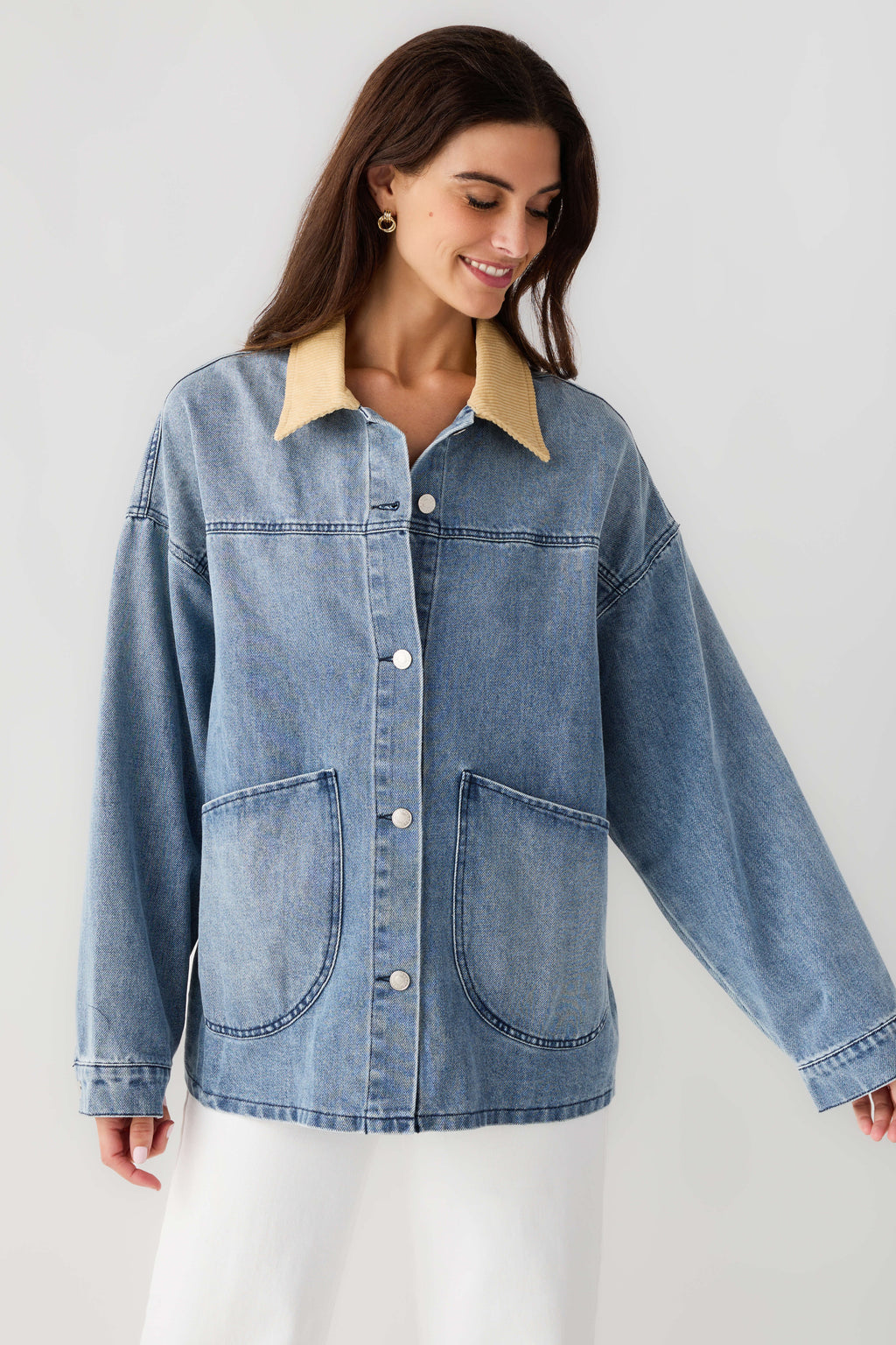 Light blue denim jacket with tan corduroy collar, chest pockets and button front