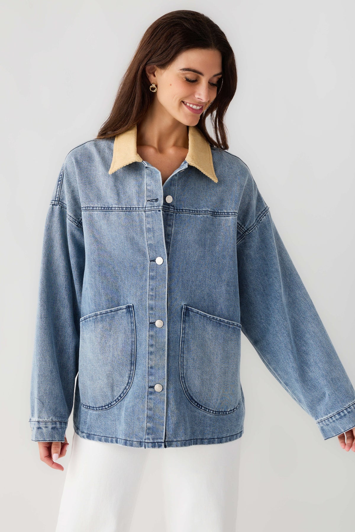 Light blue denim jacket with tan corduroy collar, chest pockets and button front