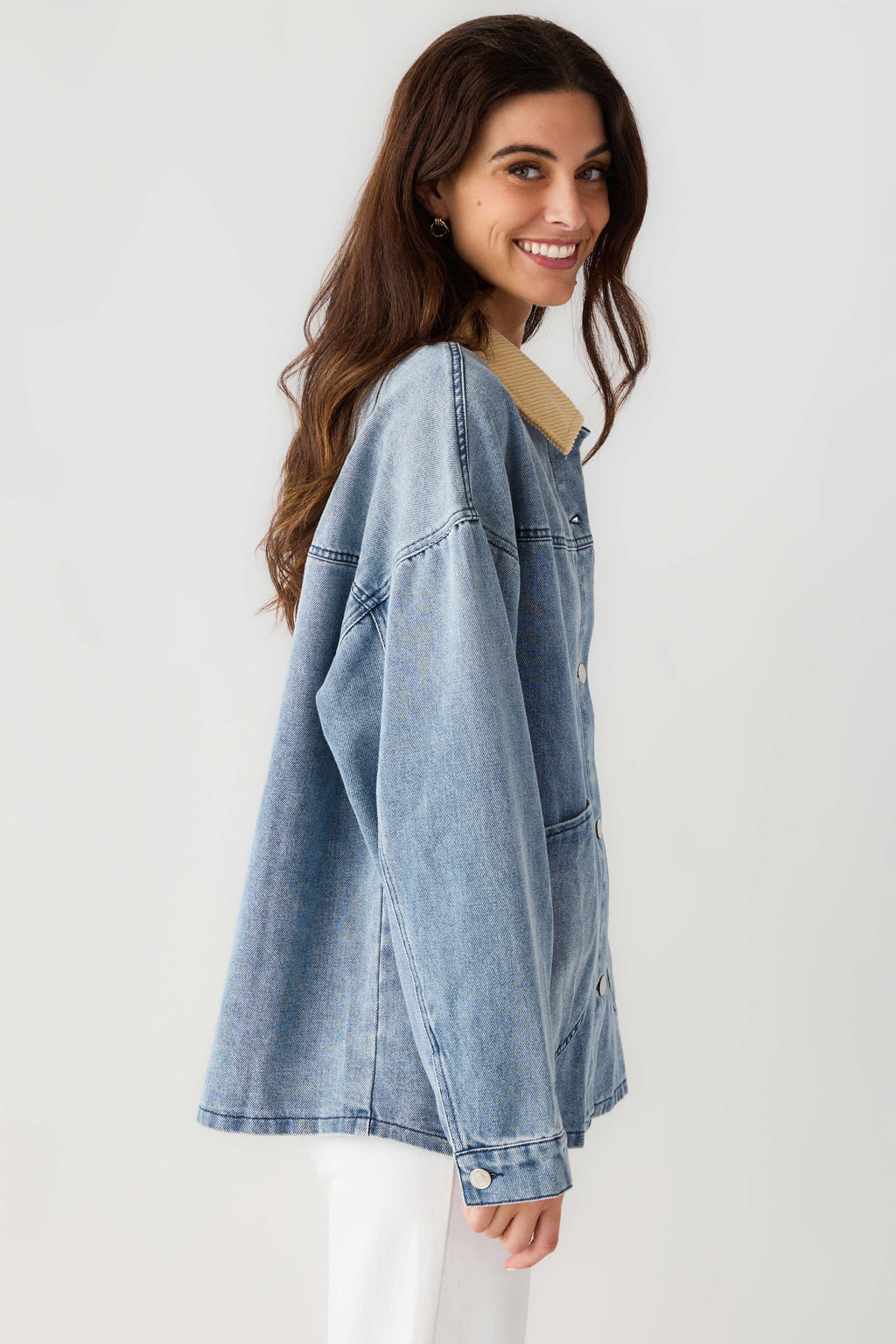 Light blue denim jacket with tan corduroy collar, button front and side seam detail