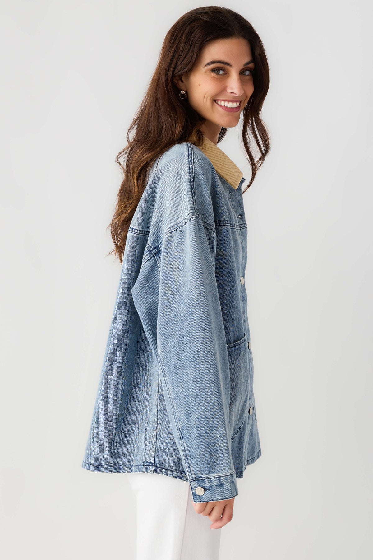 Light blue denim jacket with tan corduroy collar, button front and side seam detail