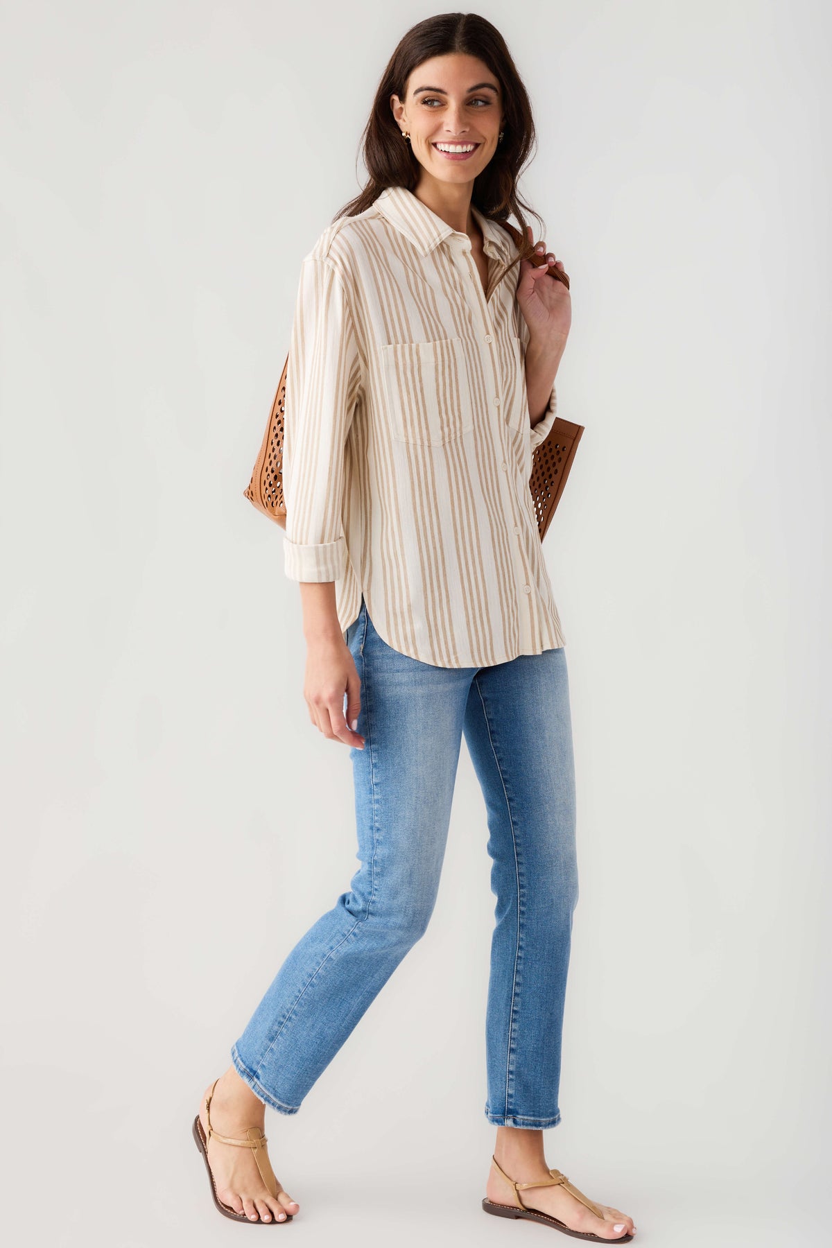 Cream and tan striped button-up shirt with long sleeves, collar, and front placket