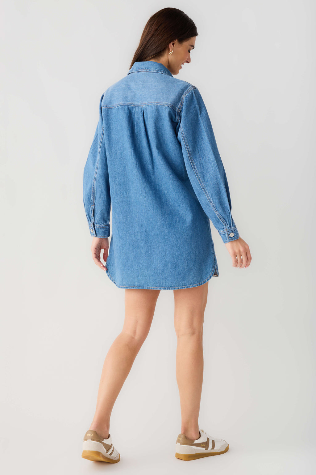 Blue denim shirt dress, back view with button placket and long sleeves.