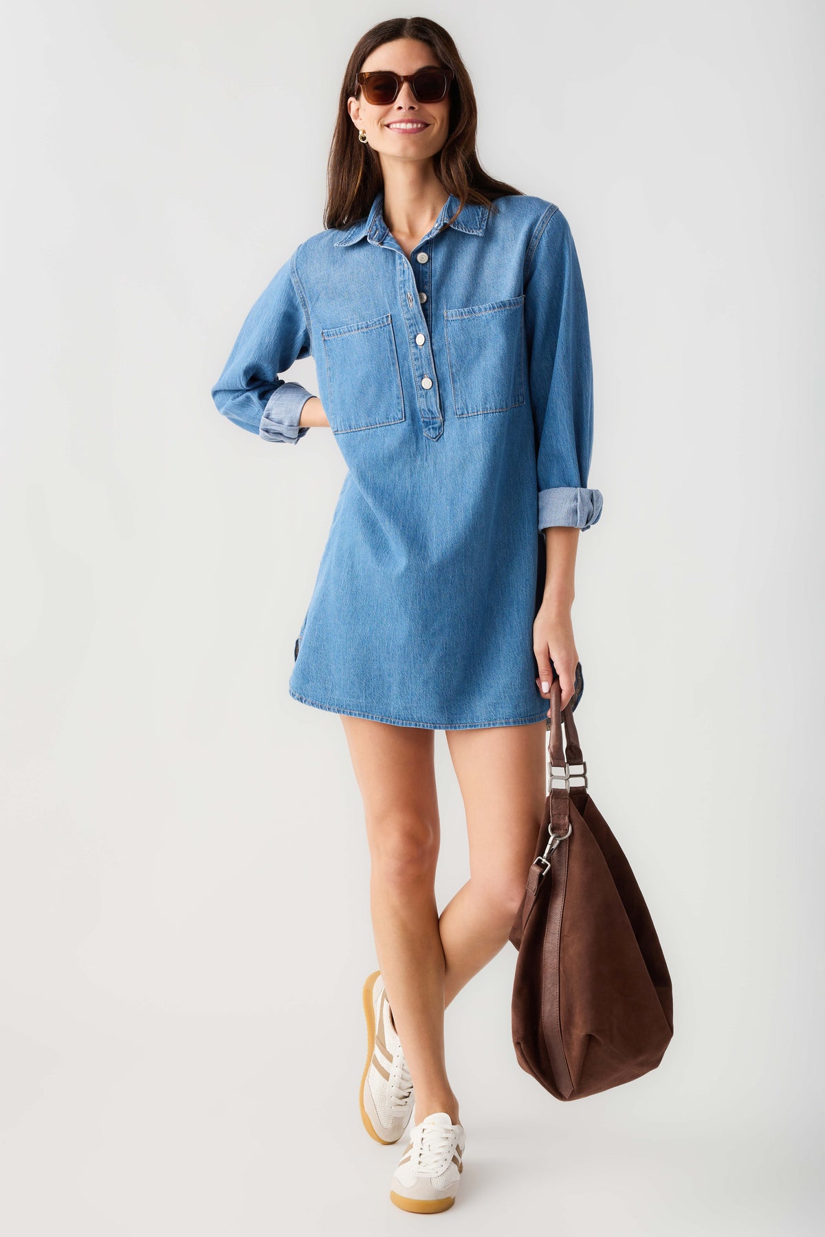 Blue denim shirt dress with collar, button front and long sleeves, front view.