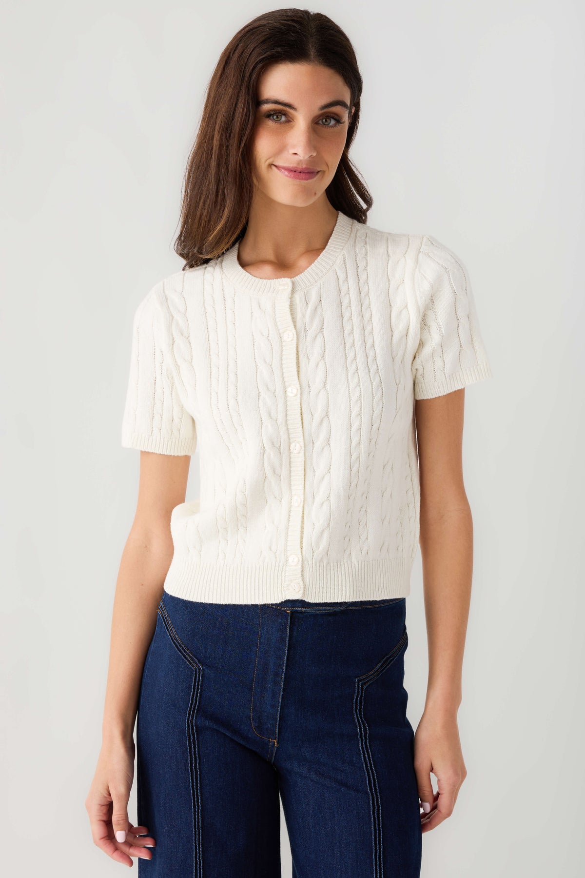 Off-white cable-knit short-sleeve cardigan with centered button-front detail