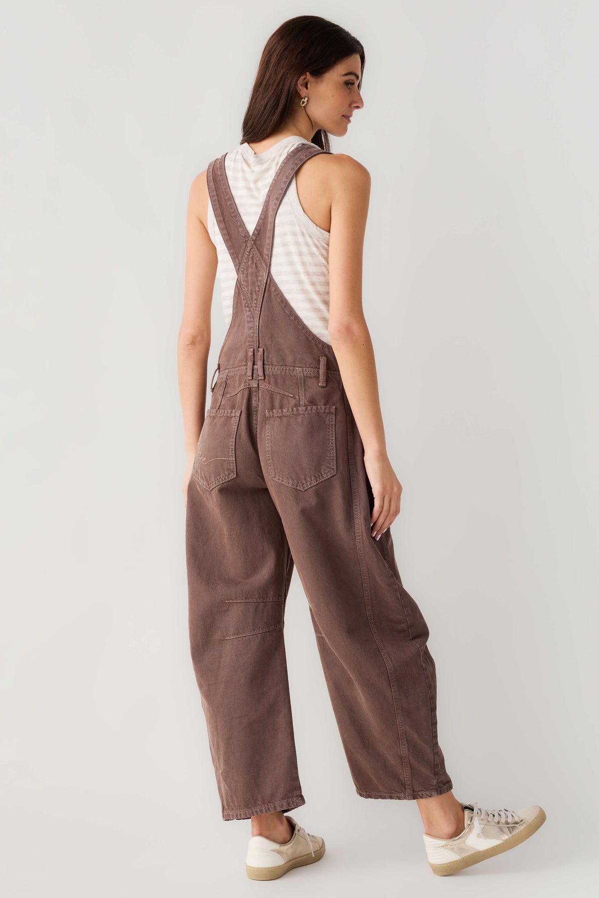 Chocolate brown denim overalls, back view with adjustable straps and patch pockets on legs