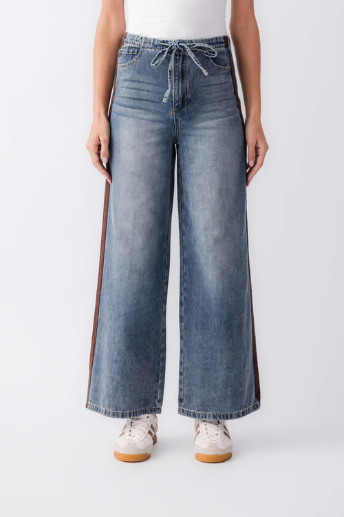 Wide-leg denim jeans with front pockets, drawstring waist, and outer-leg varsity stripes