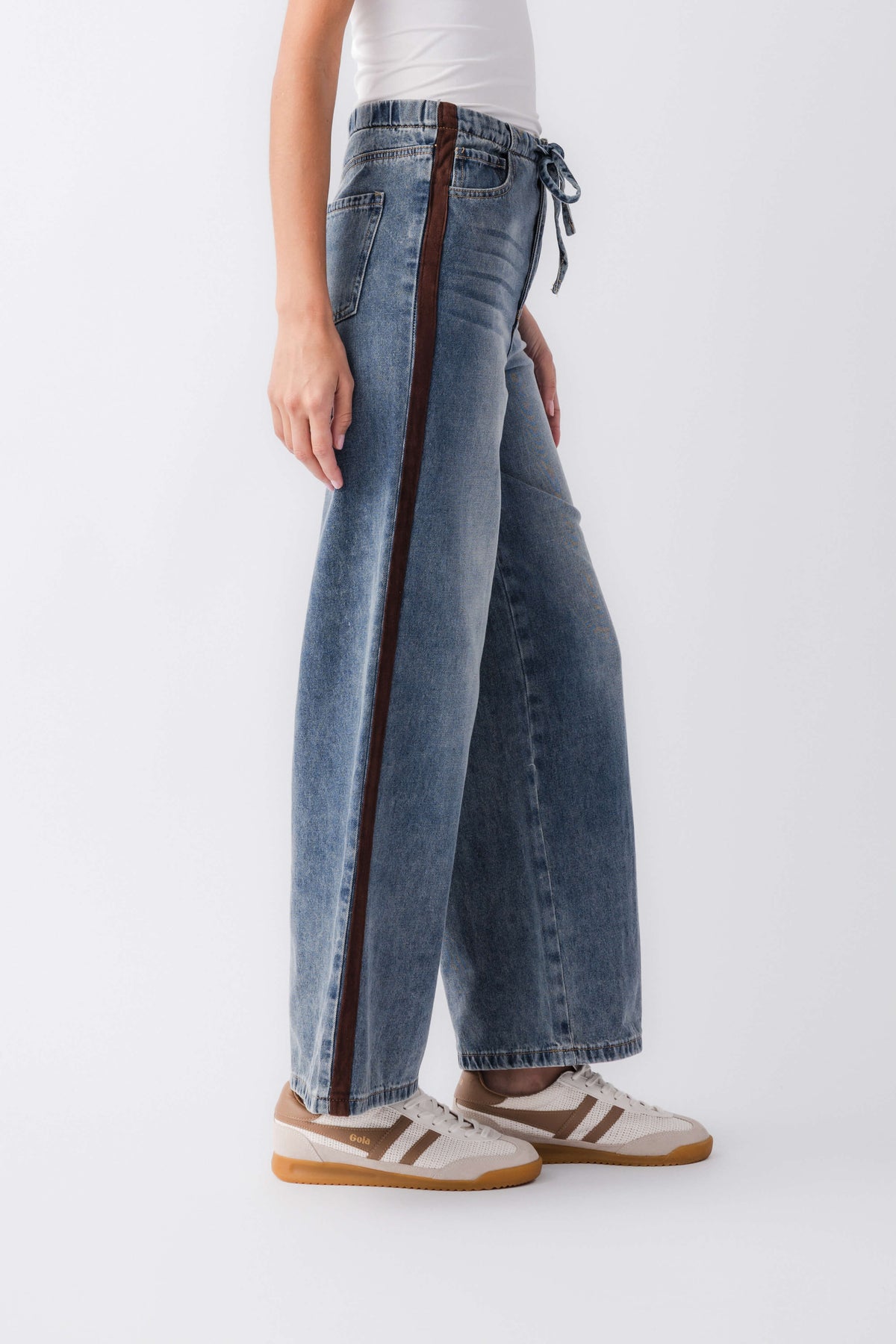 Wide-leg denim jeans with varsity side stripe and drawstring ties at the waistband