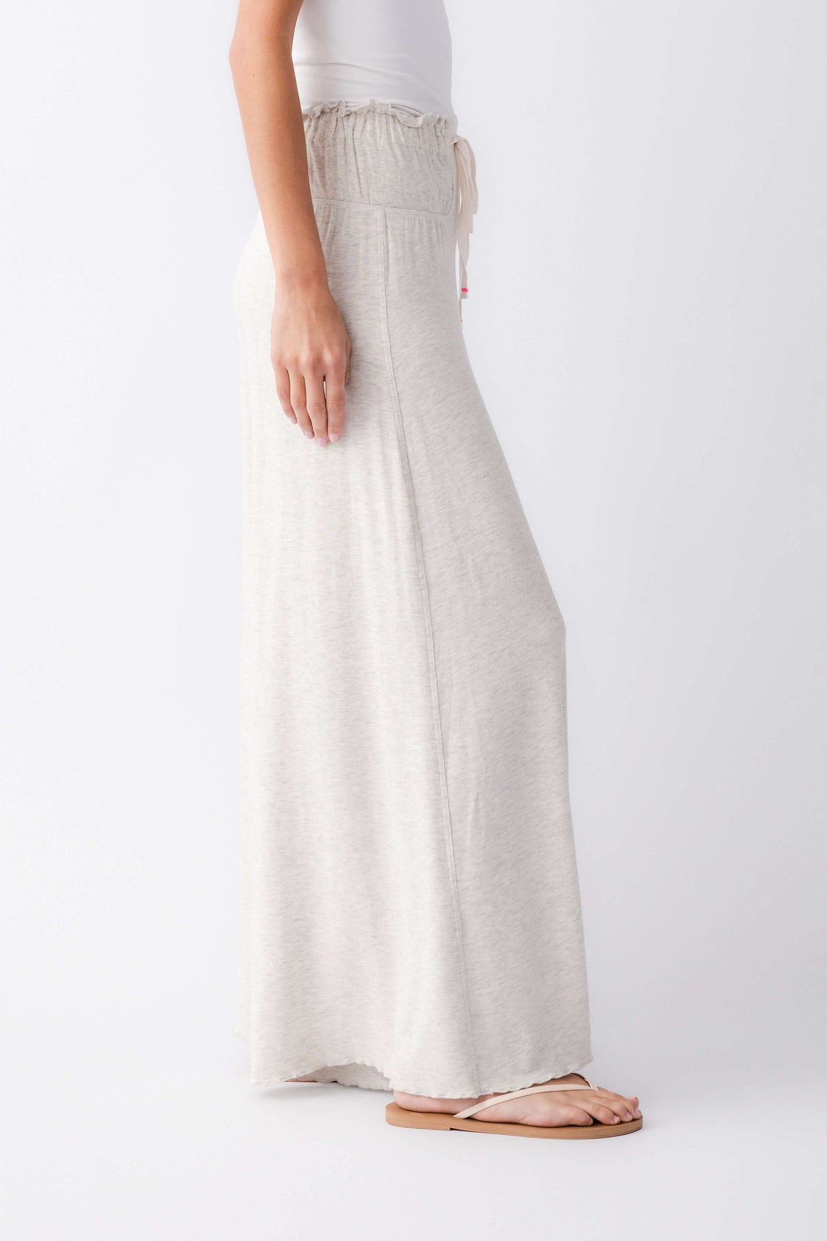 Heather grey wide-leg pants with elastic waistband and drawstring; side view
