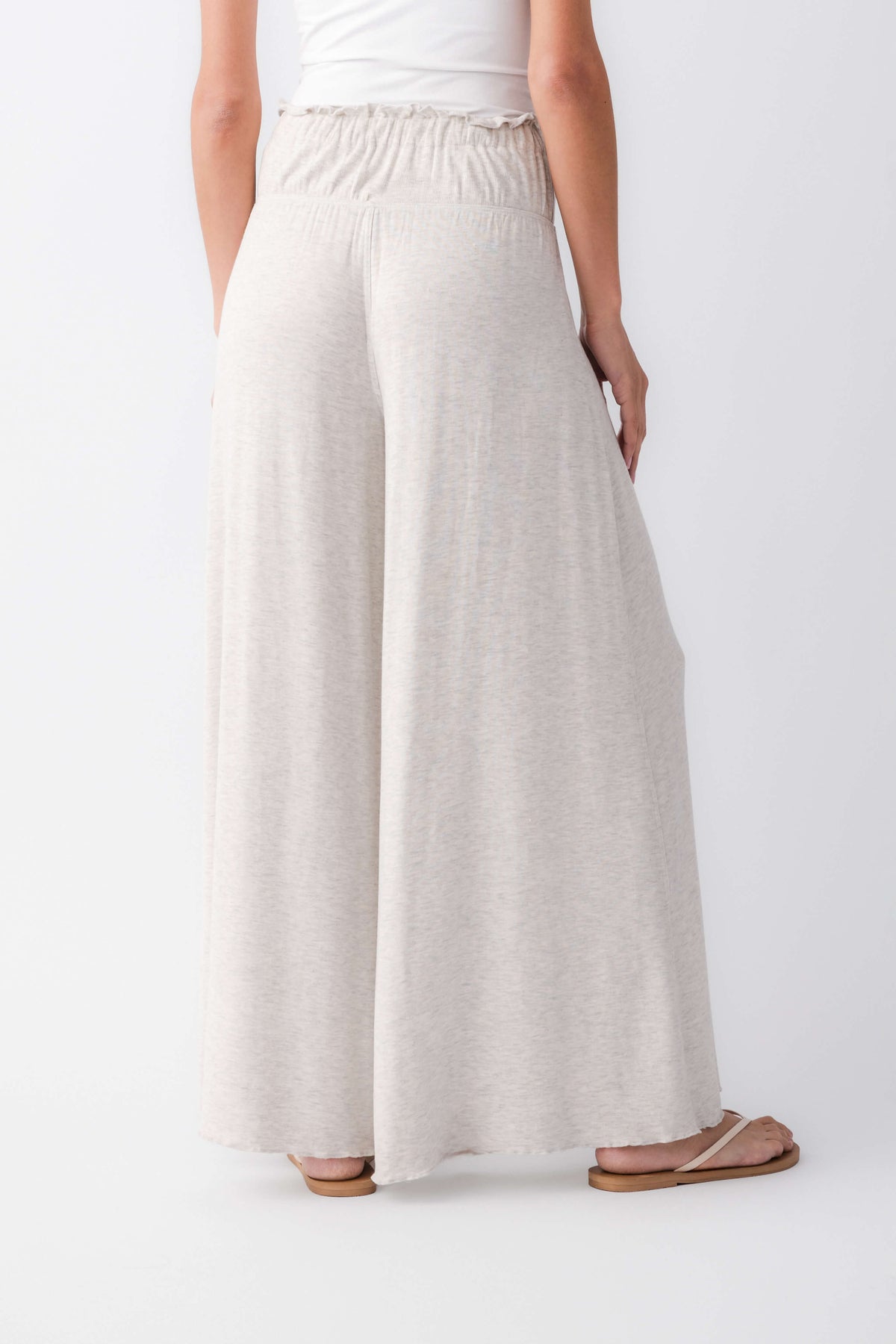 Heather grey wide-leg pants with elastic waist and drawstring; back view