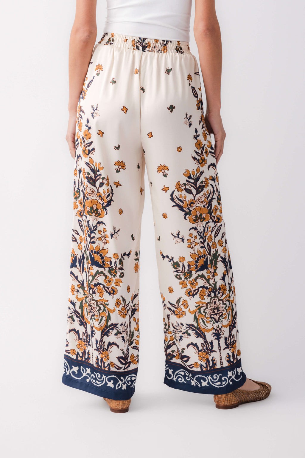Ivory satin pants with elastic waistband and navy floral border