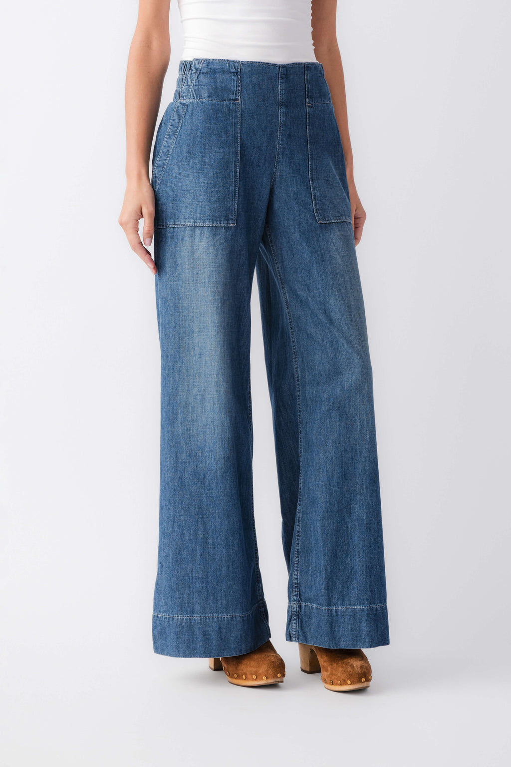 Blue denim pull-on wide-leg pants with front patch pockets and flared hems