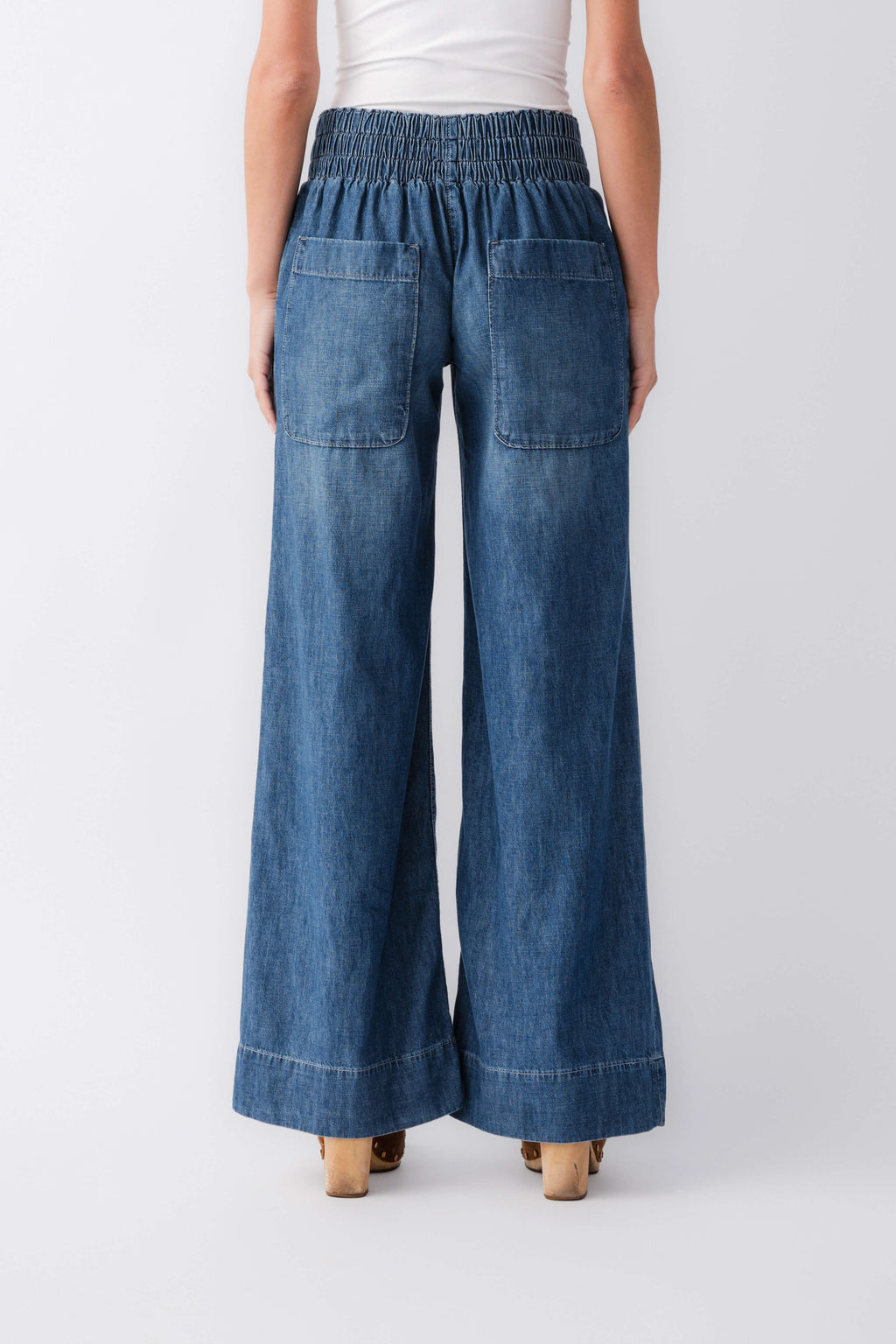 Blue denim pull-on wide-leg pants with elastic waistband and hip patch pockets