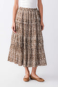 Front view of mocha printed tiered maxi skirt with elastic waist and ornate brown/black motif
