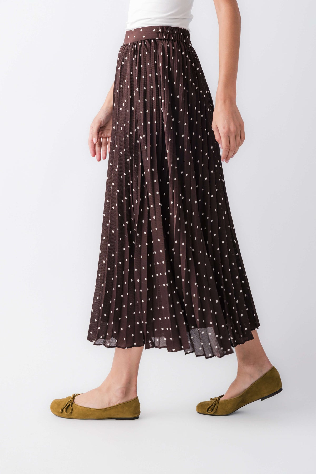 Brown sheer pleated maxi skirt with tiny white dot pattern and elastic waist