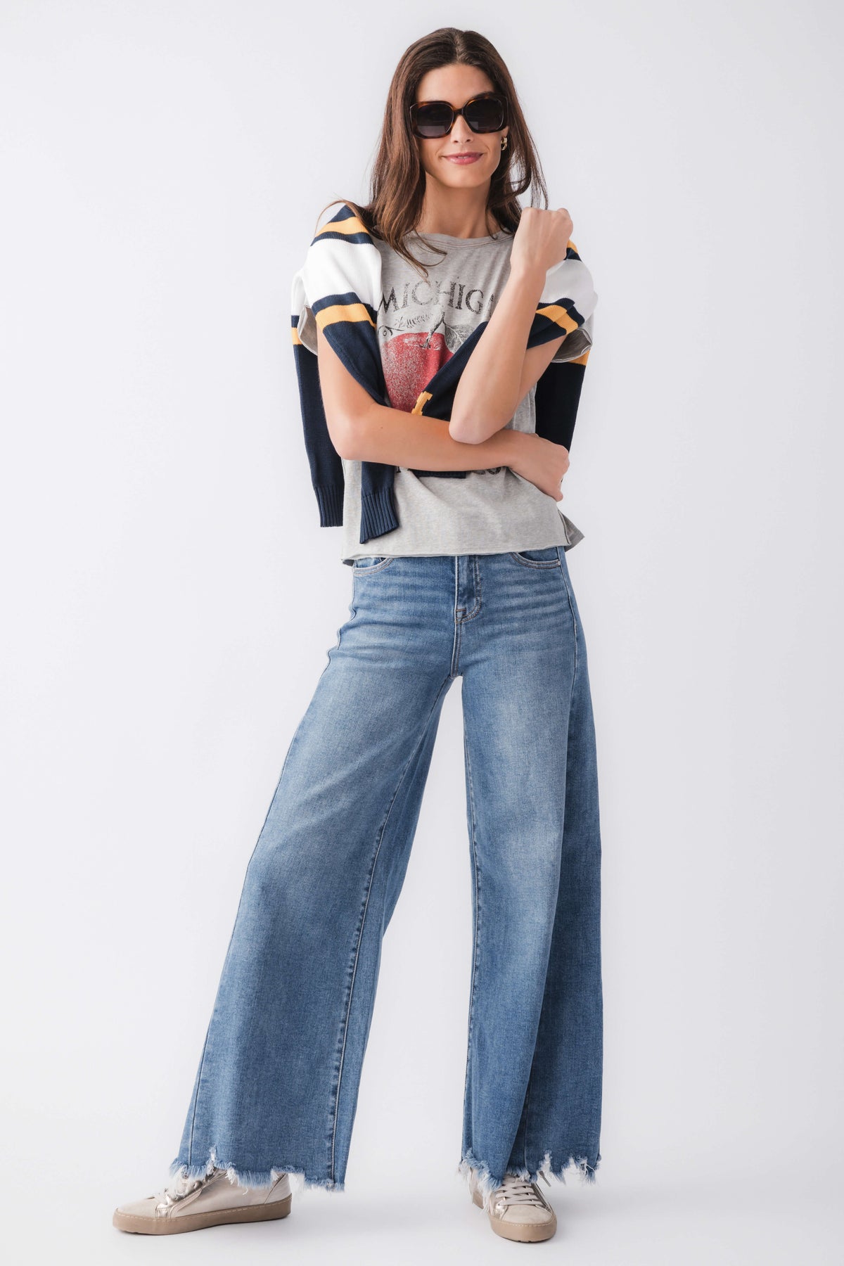 Medium wash high-rise ultra wide leg jeans with wide leg opening and frayed cuffs.