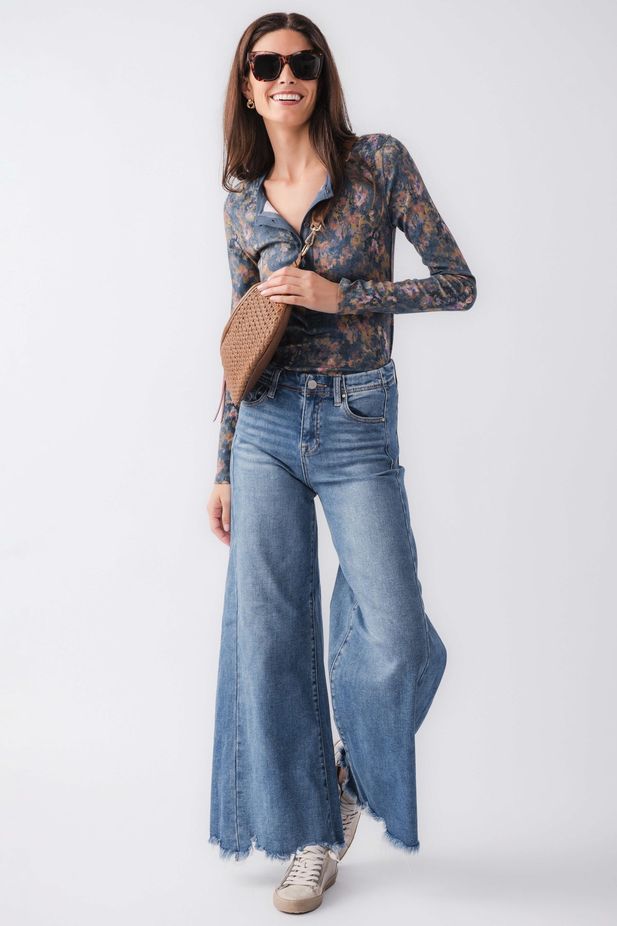 Medium wash high-rise ultra wide leg jeans with front pockets and frayed bottom hem.