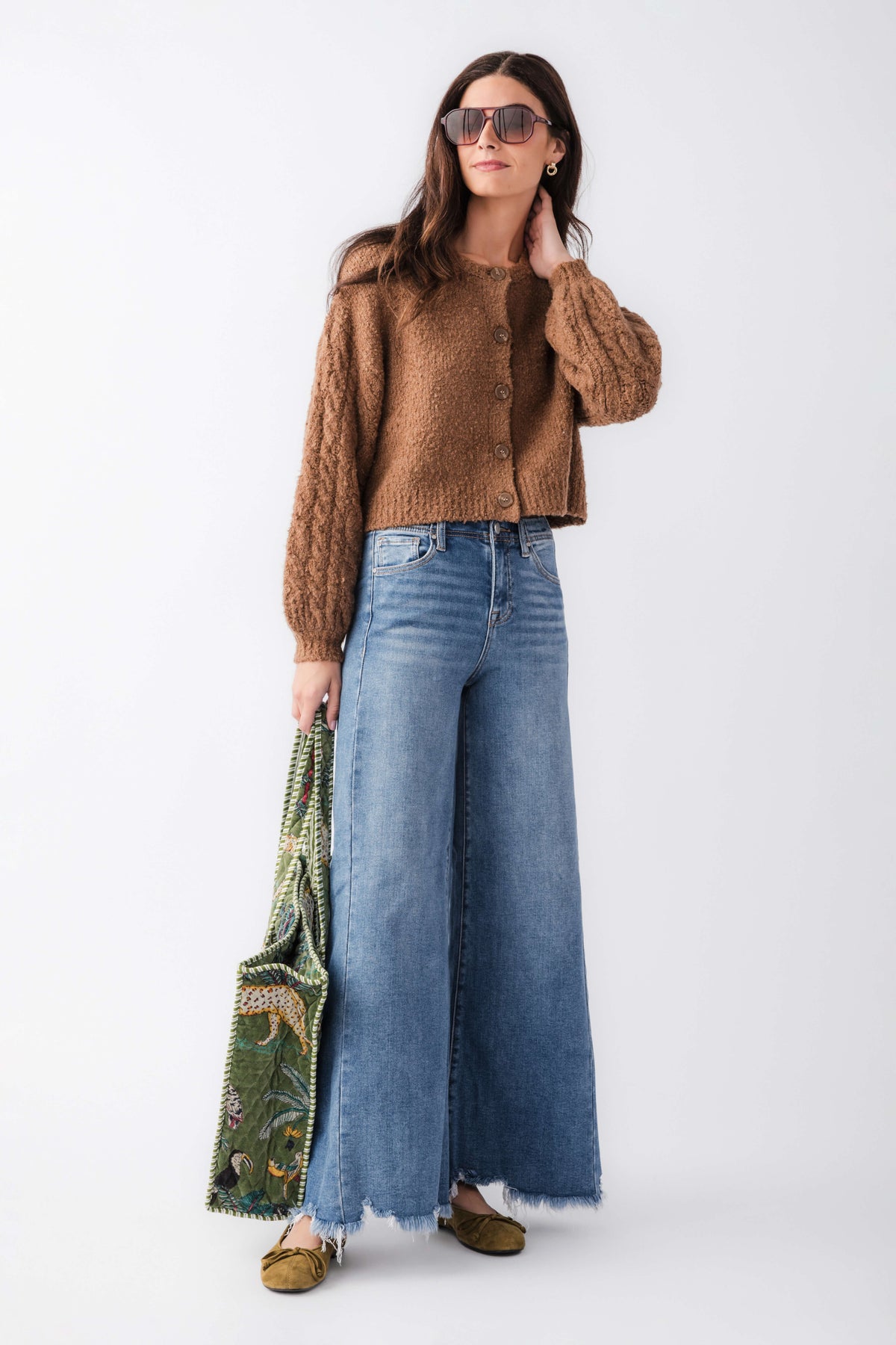 Brown button-up cardigan worn with wide-leg jeans