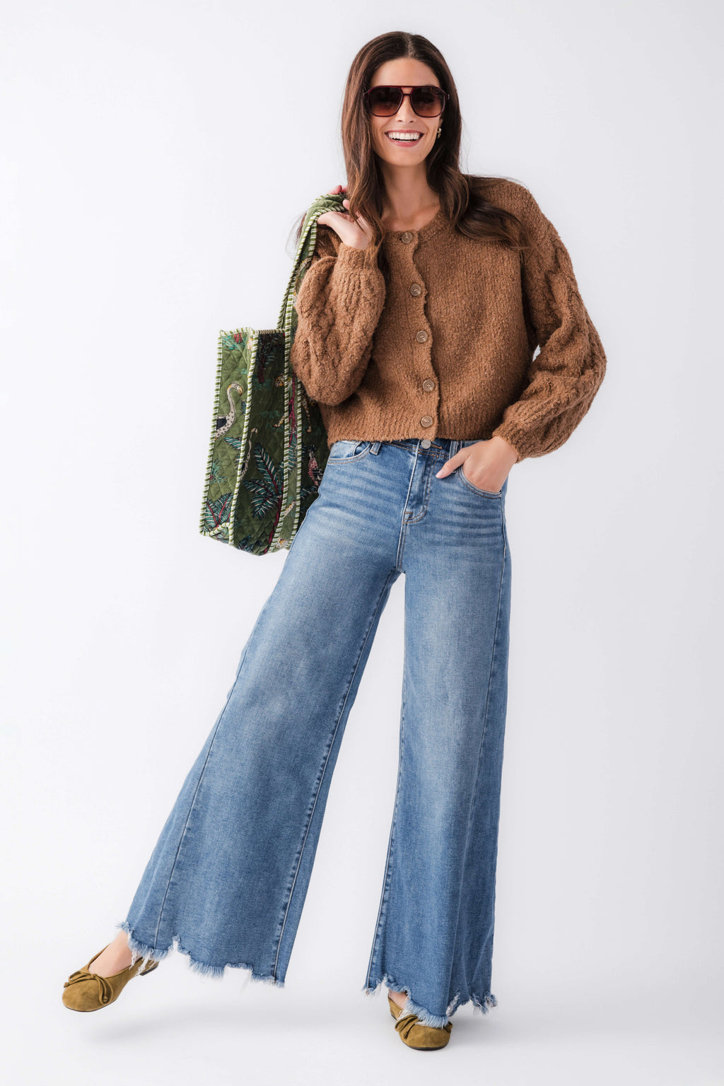 High-rise ultra wide leg medium wash jeans with distressed frayed hem and back pockets.