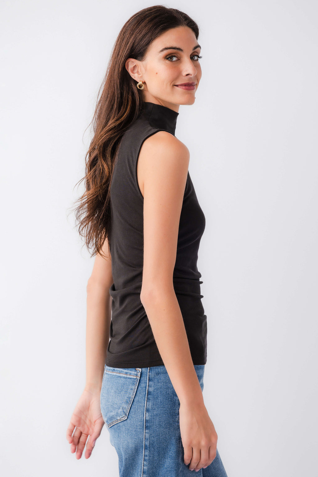Black sleeveless high-neck tank top, side profile with clean armholes