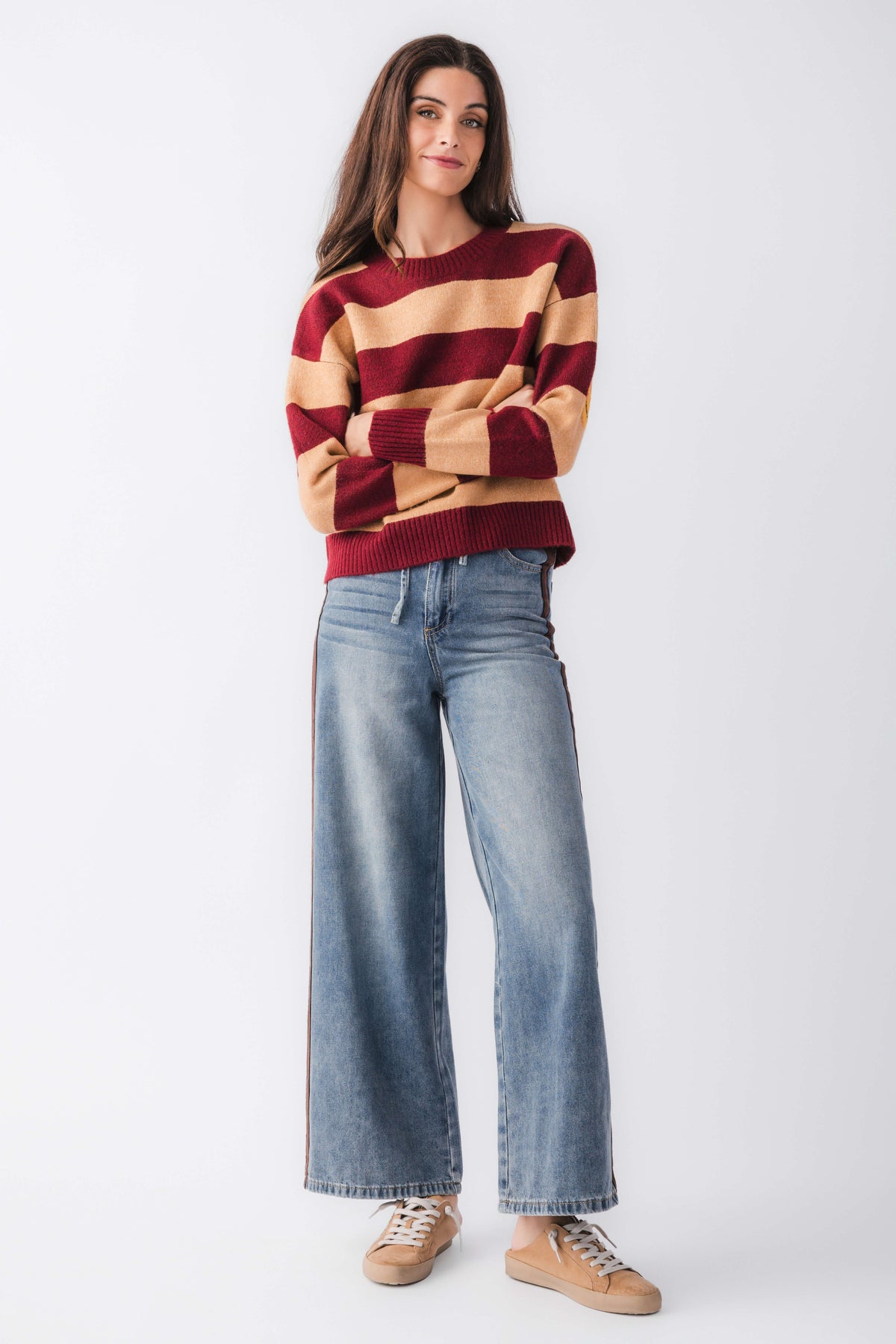 Burgundy and camel striped crewneck sweater with smiley face patch, ribbed cuffs and hem