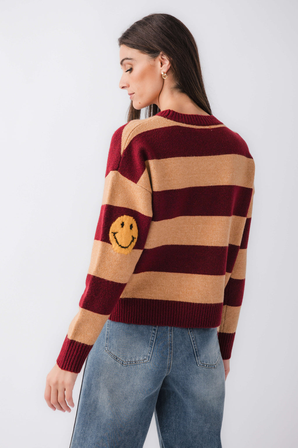 By Together striped sweater back view with smiley face patch, burgundy and camel stripes.