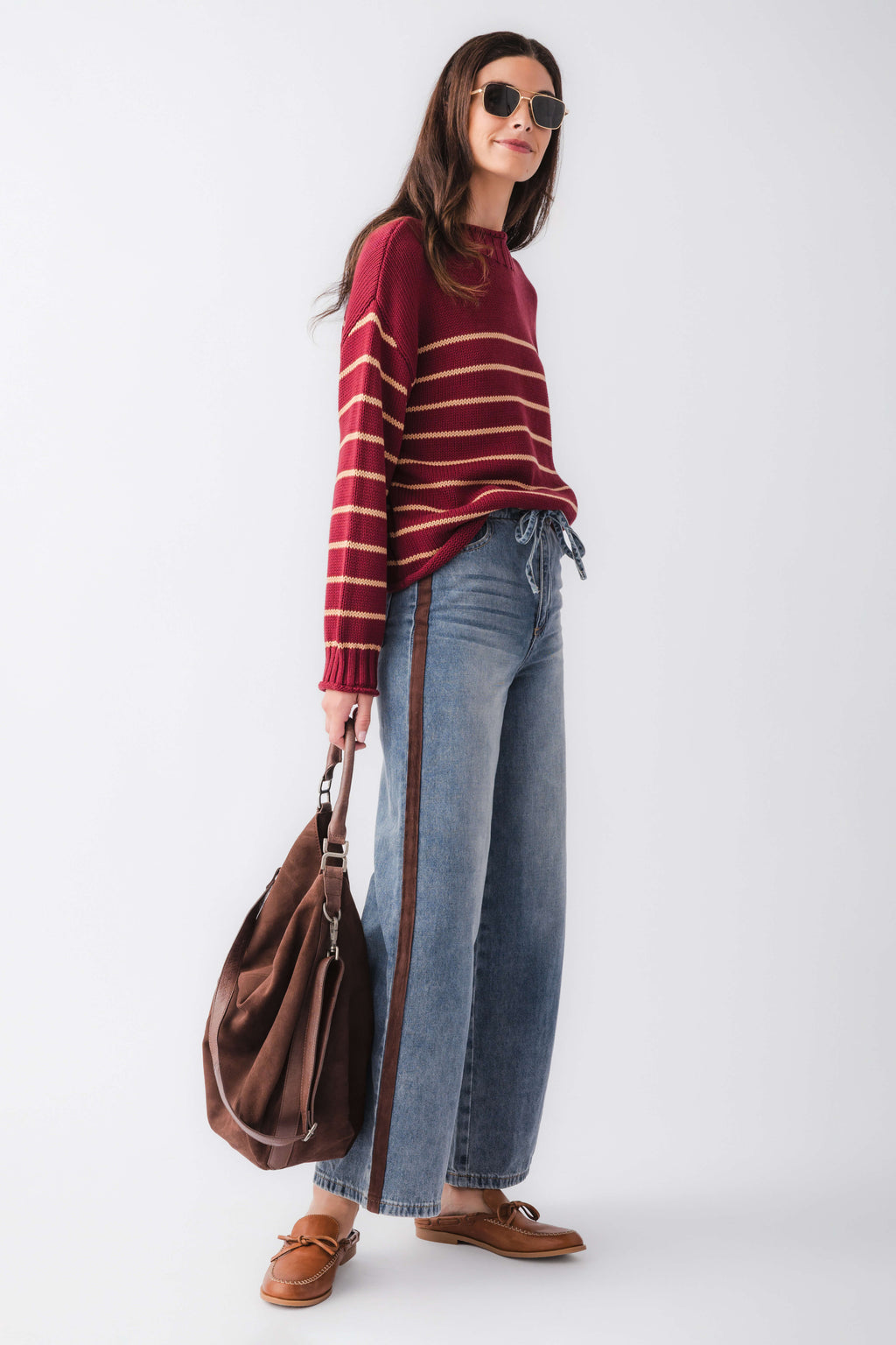 Burgundy striped knit mockneck sweater, standing side view