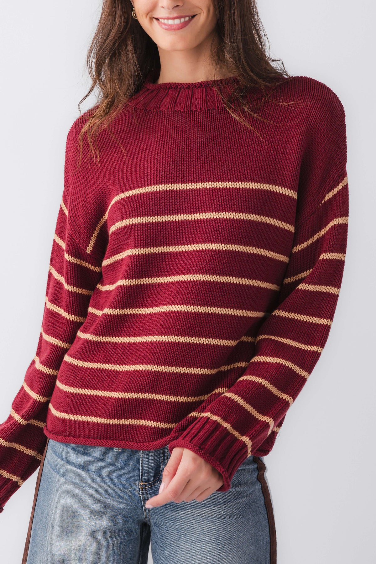 Burgundy striped knit mockneck sweater with long sleeves and ribbed neckline
