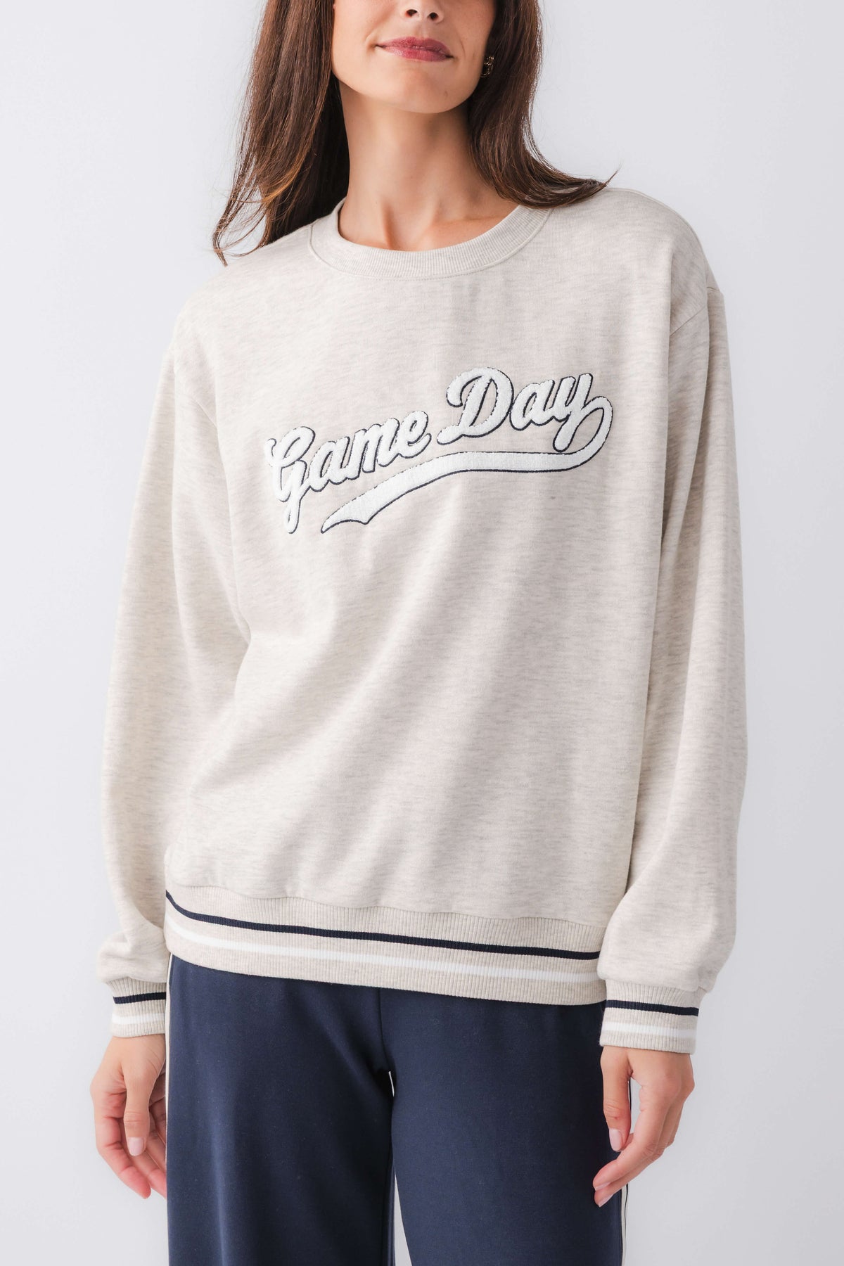 Light gray sweatshirt with 'Game Day' script graphic, ribbed cuffs and hem