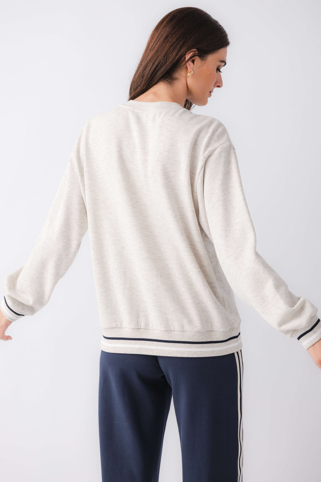 Light gray crewneck sweatshirt back view with ribbed cuffs and striped hem