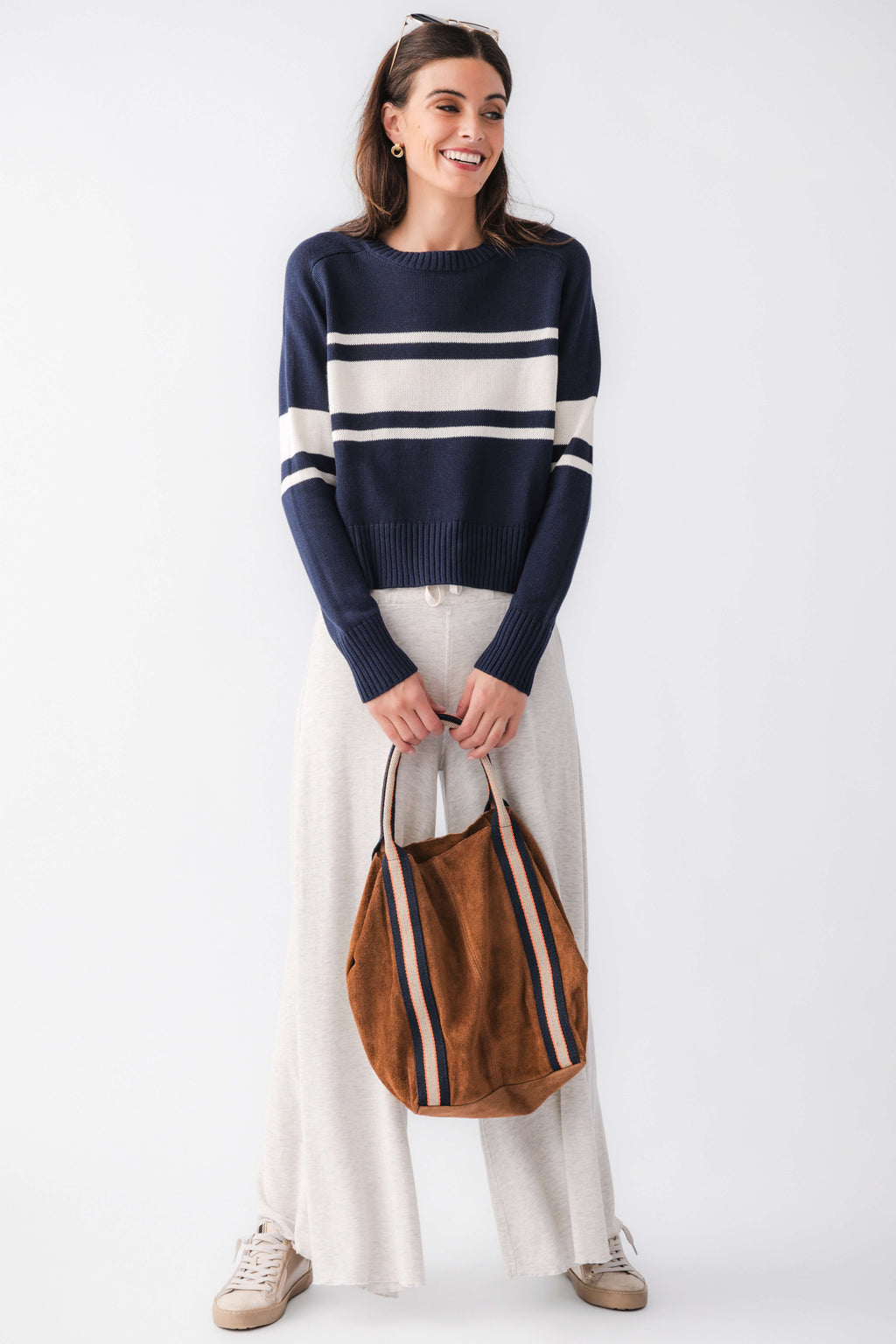 Navy crewneck sweater with cream horizontal stripes and long sleeves