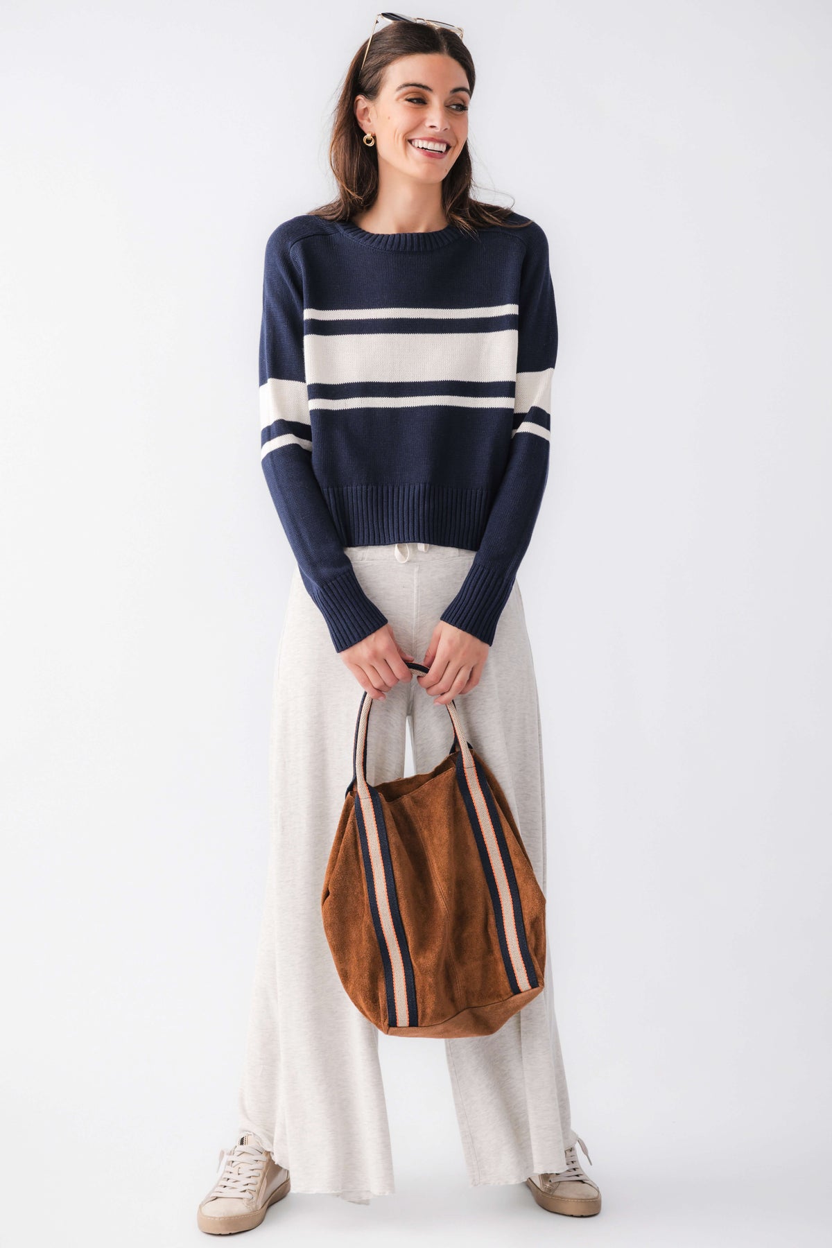 Navy crewneck sweater with cream horizontal stripes and long sleeves