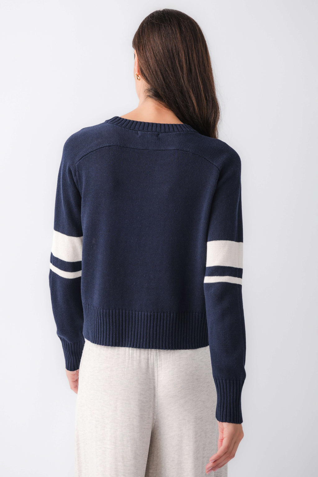 Navy back view sweater with cream stripe across yoke and long sleeves