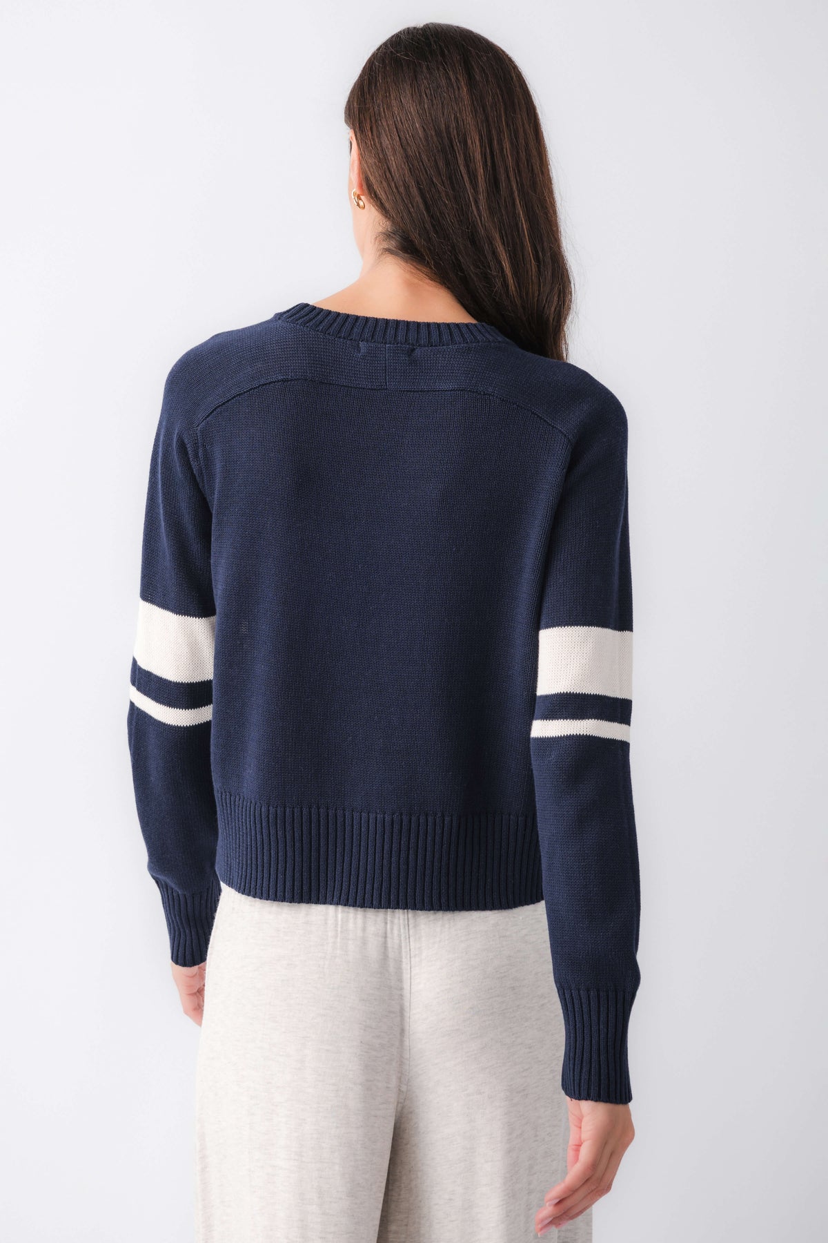 Navy back view sweater with cream stripe across yoke and long sleeves