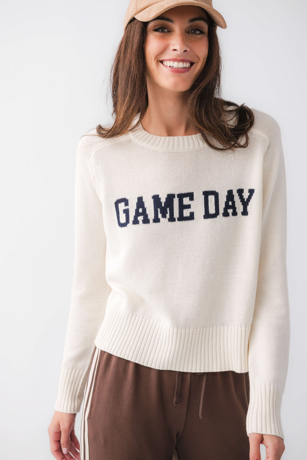 Cream crewneck sweater with 'GAME DAY' varsity graphic and ribbed cuffs