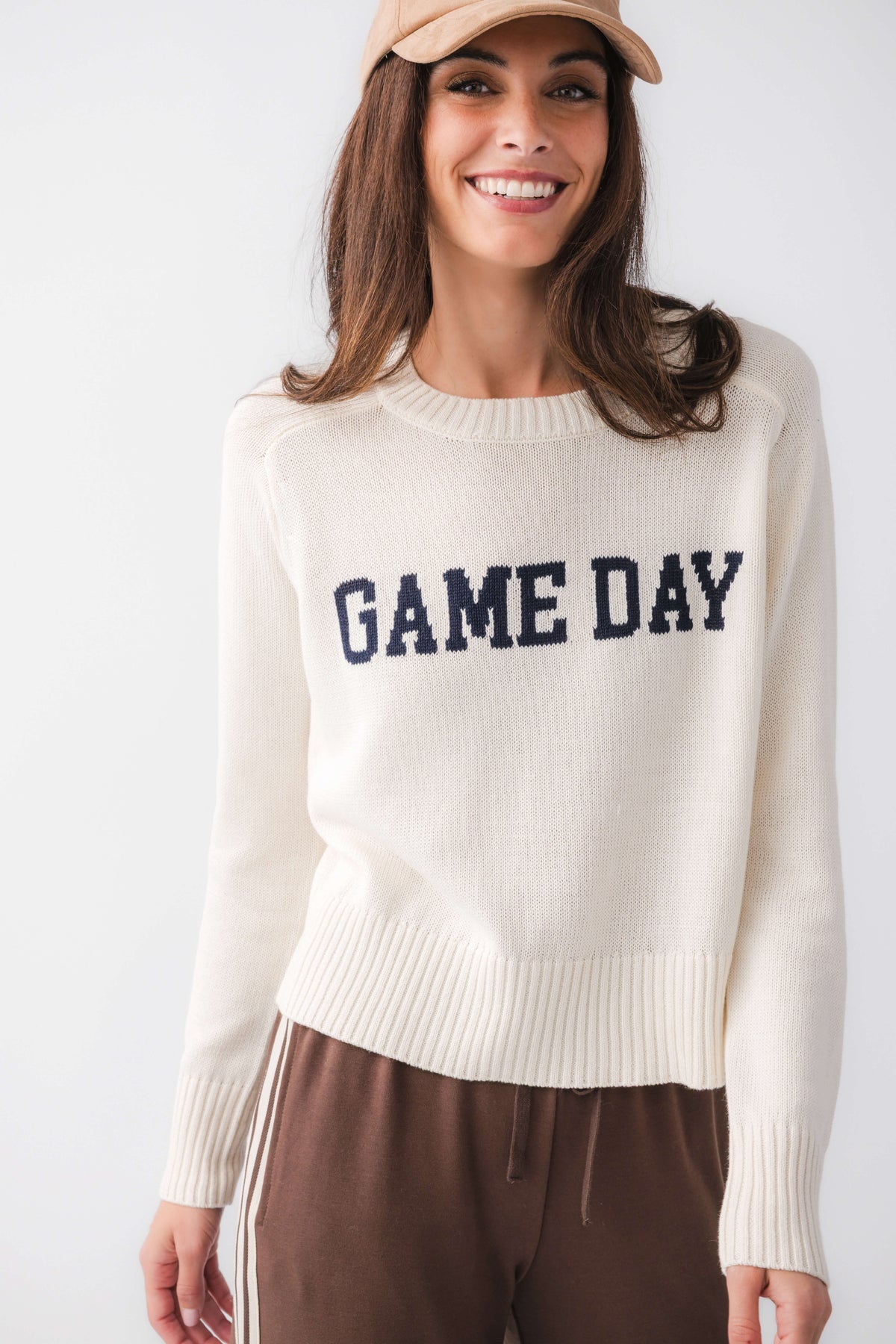 Cream crewneck sweater with 'GAME DAY' varsity graphic and ribbed cuffs