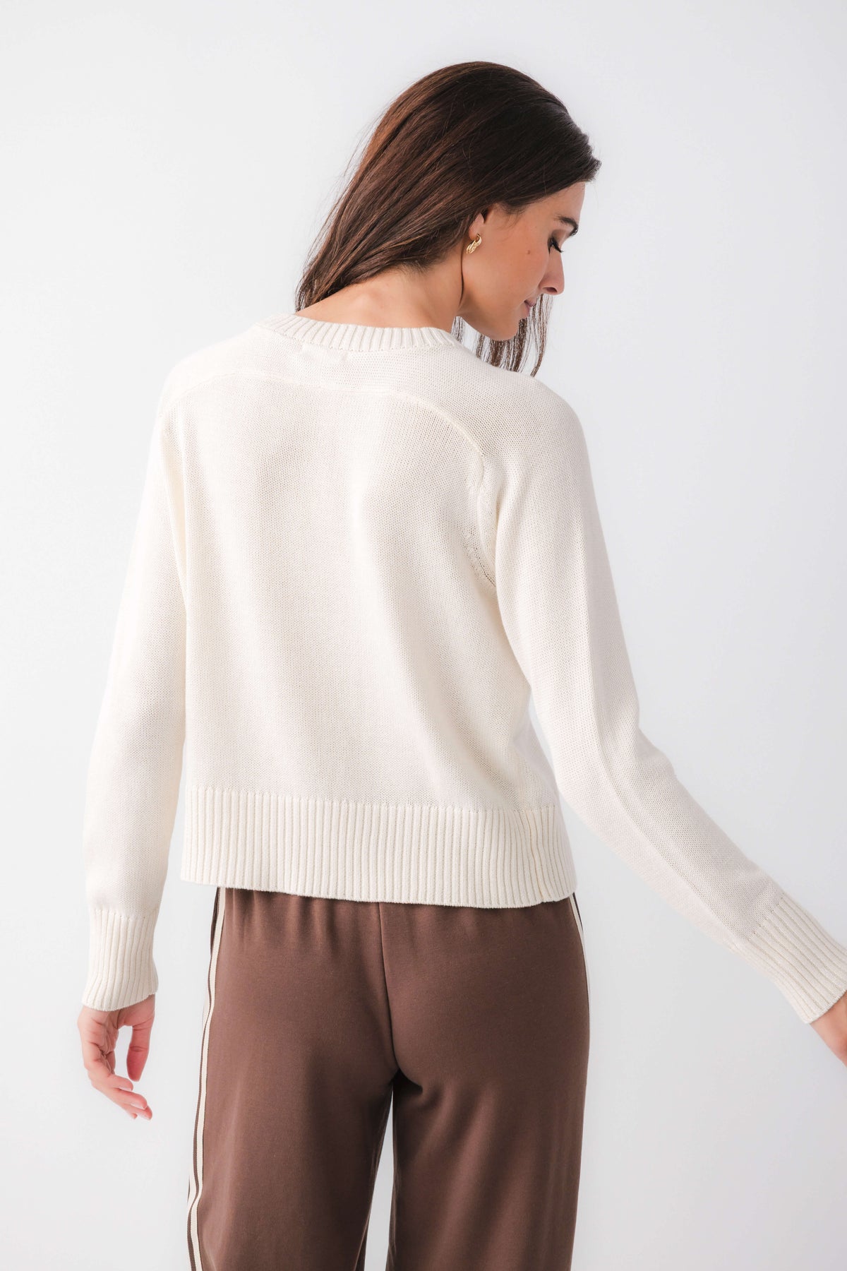 Cream crewneck sweater with ribbed hem and cuffs, back view