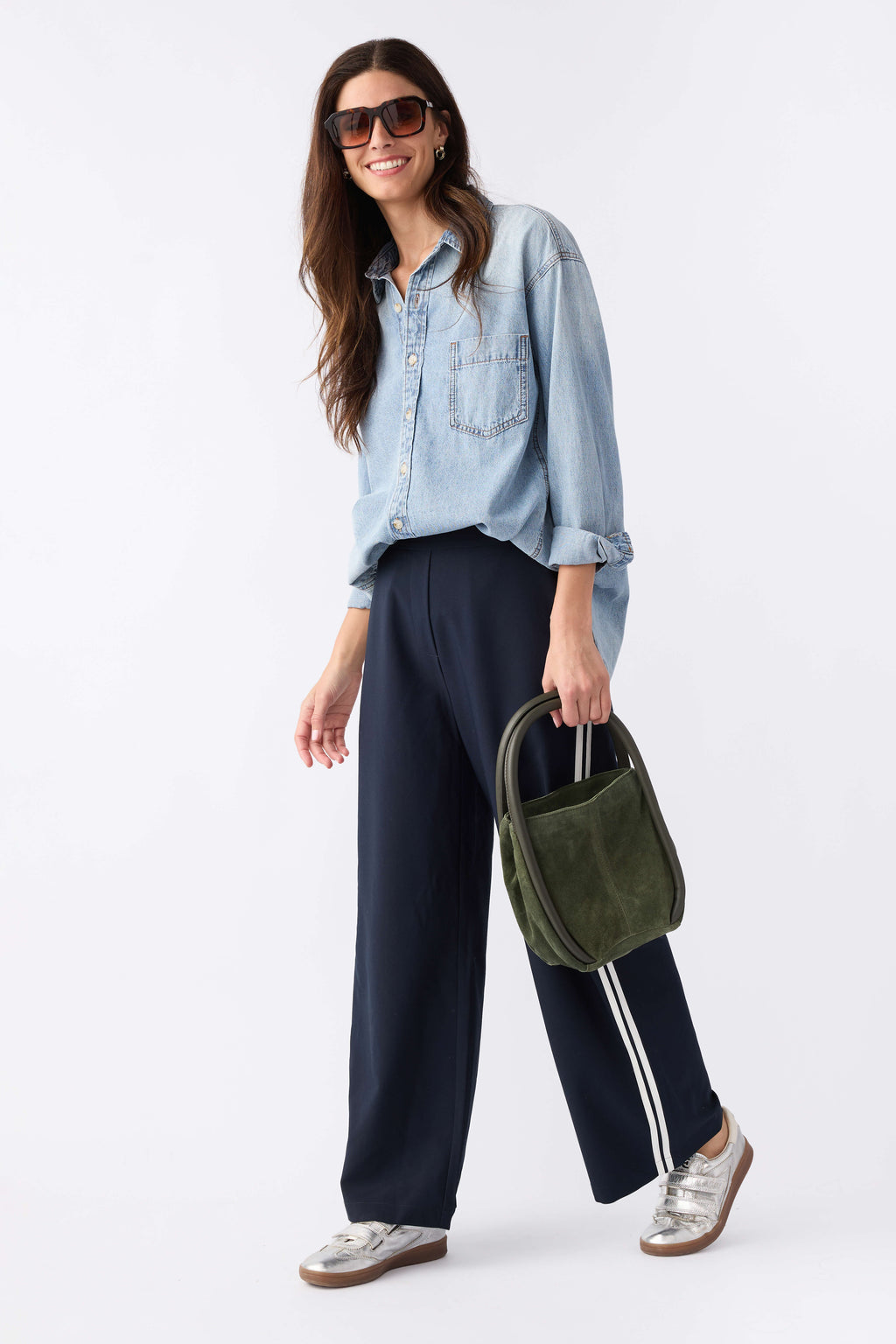 Navy track pants with white side stripe accents and loose wide-leg design
