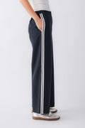 Navy pull-on track pants with white side stripes and wide straight legs