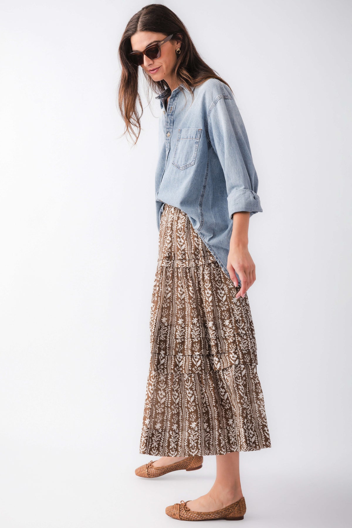 Side view of mocha printed tiered maxi skirt with gathered tiers and ornate brown/black pattern