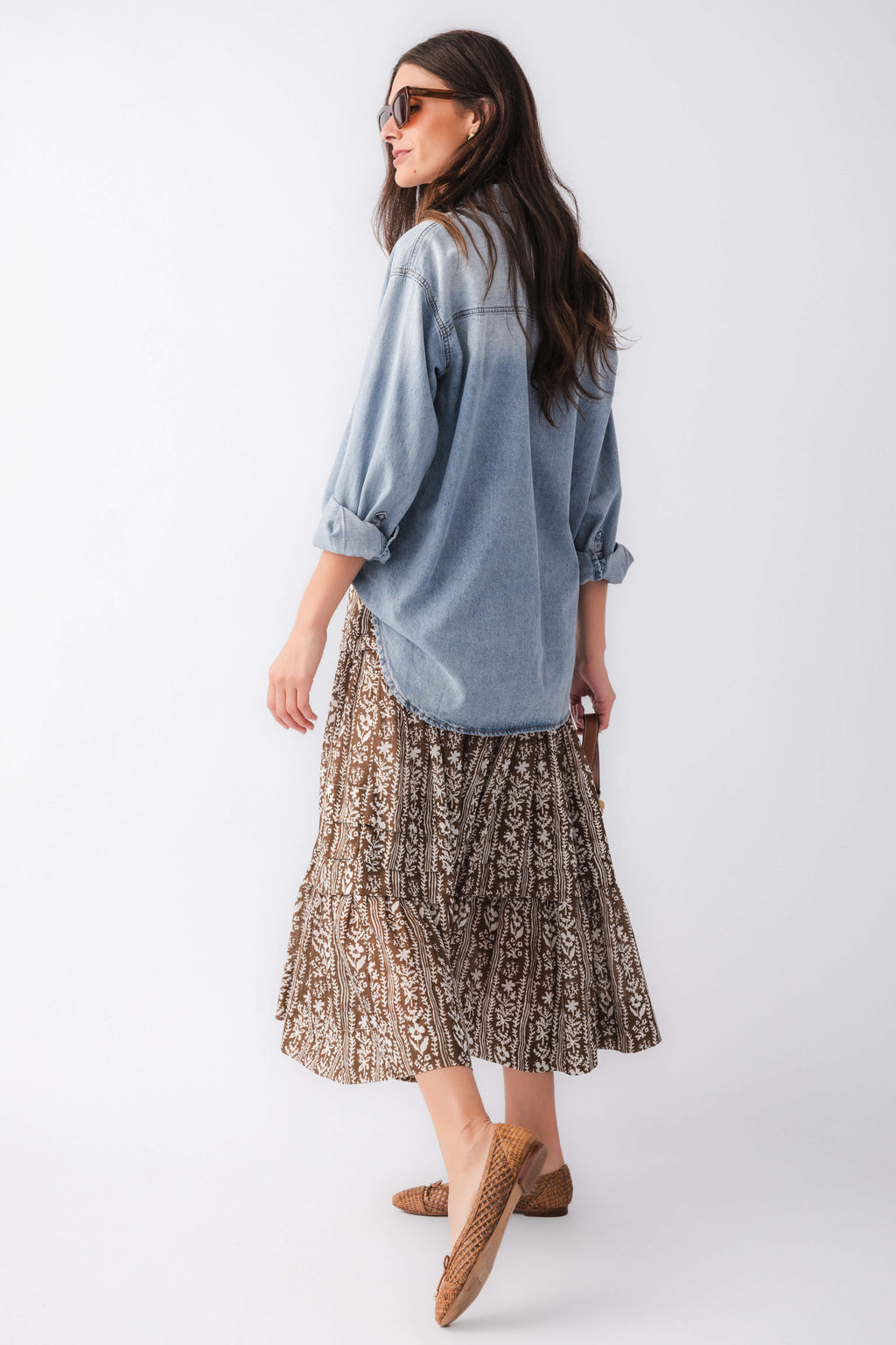 Back view of mocha printed tiered maxi skirt with gathered ruffle tiers, brown and black