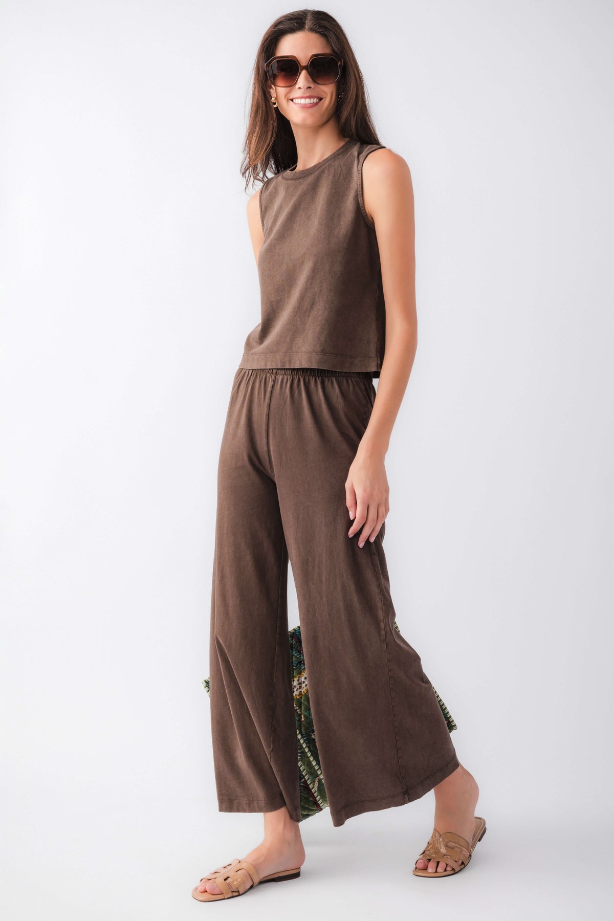 Dark brown jersey crop flare pants with elastic waist and wide flare hem