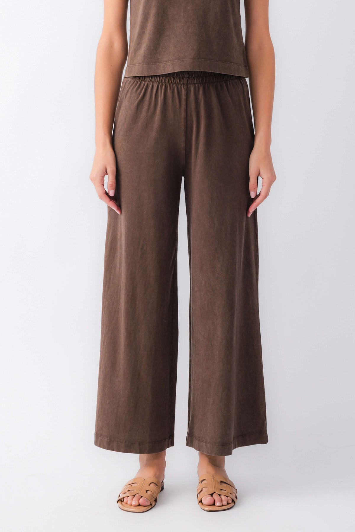 Dark brown jersey crop flare pants with elastic waistband, wide straight legs