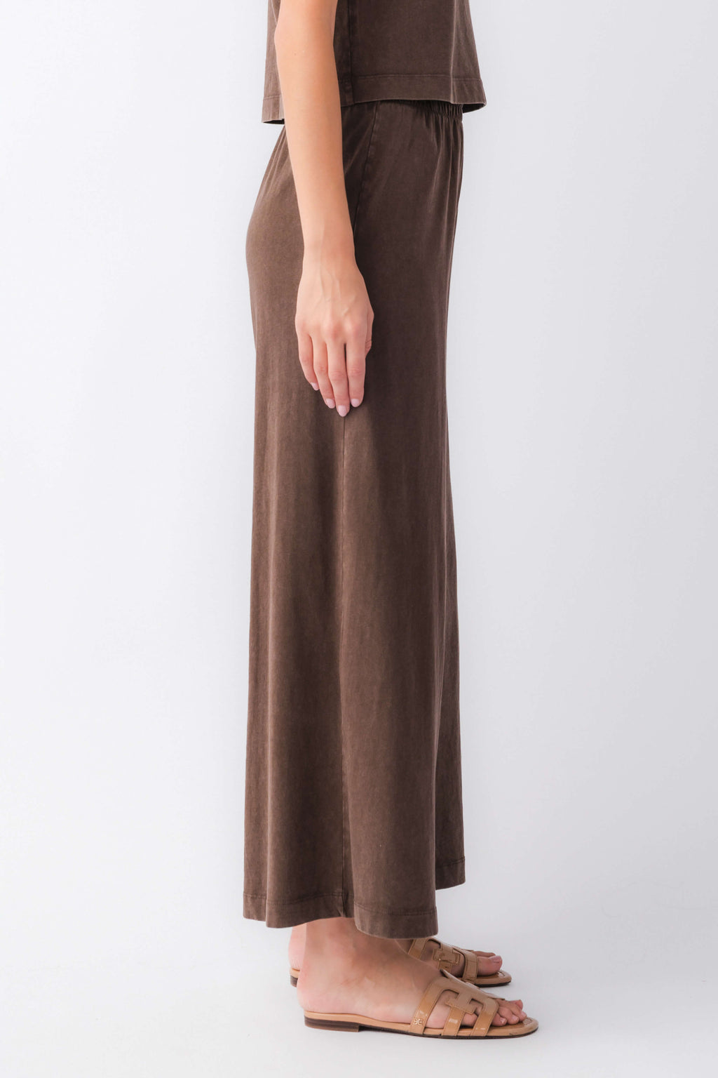 Dark brown jersey crop flare pants with elastic waist, side view
