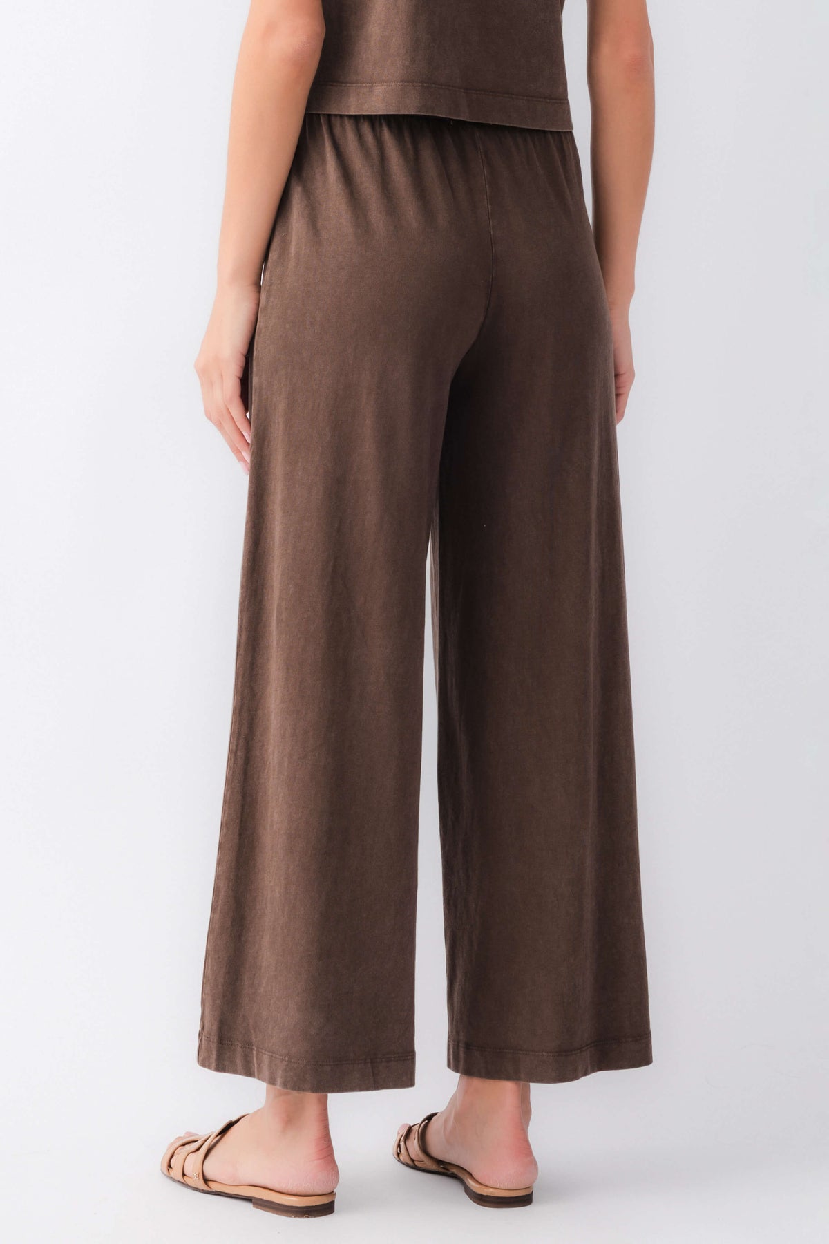 Dark brown jersey crop flare pants with elastic waist, wide legs
