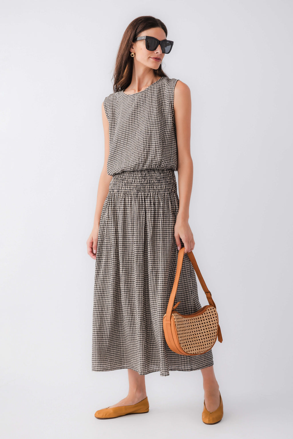 Black and white gingham sleeveless top, side view, with gathered waist