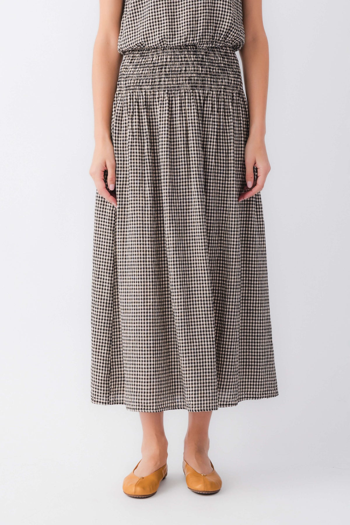 Black-and-white gingham midi skirt with elastic waist and full gathered panels