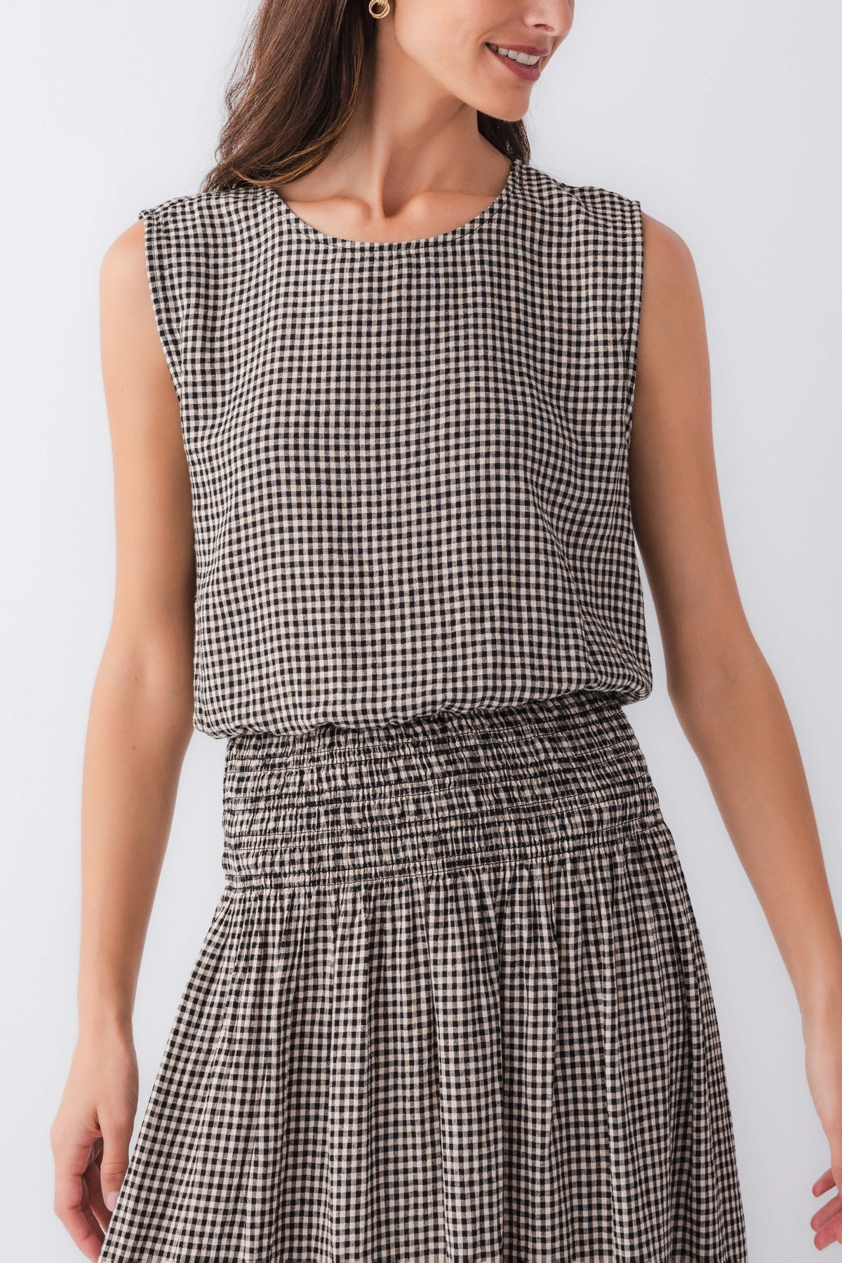 Sleeveless gingham top with crew neckline and gathered waist detail