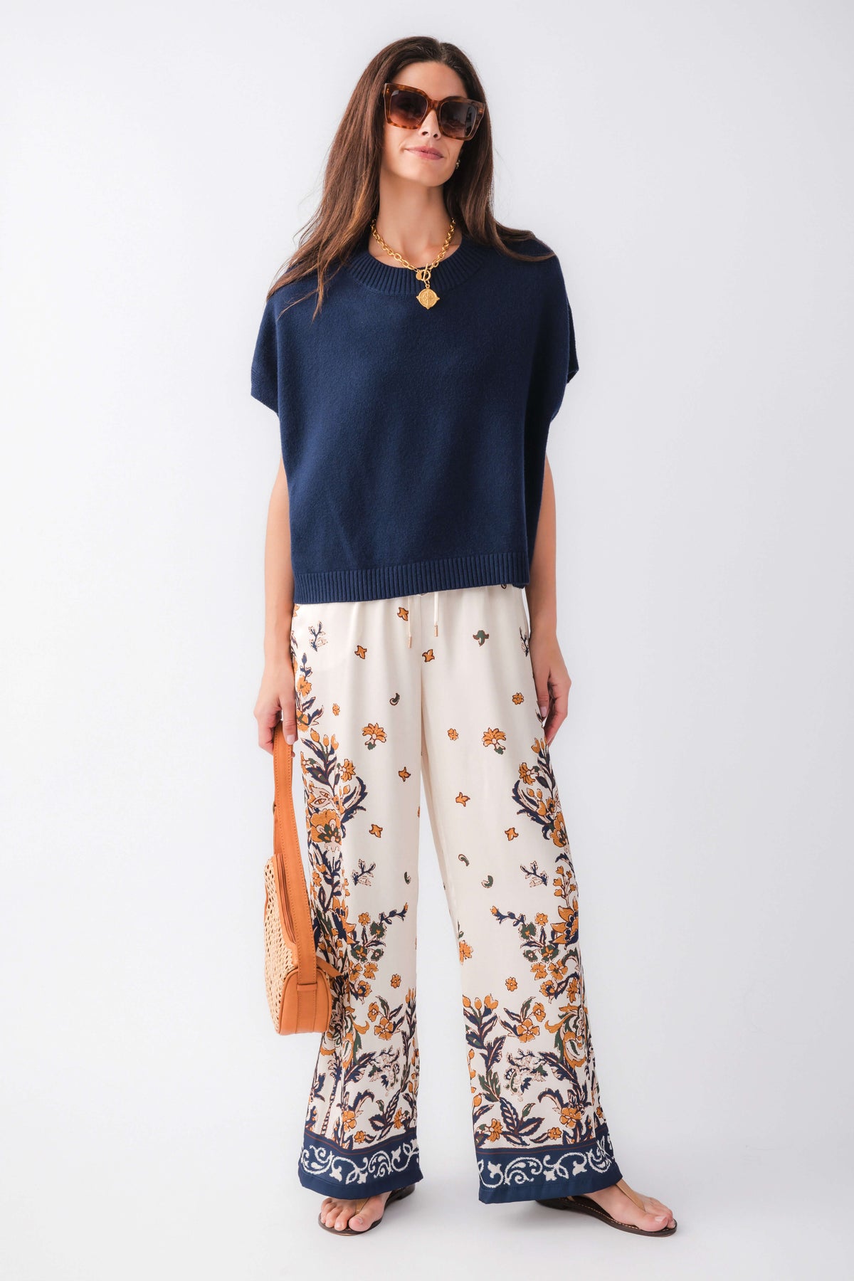 Ivory satin wide-leg pants with navy floral print and border hem