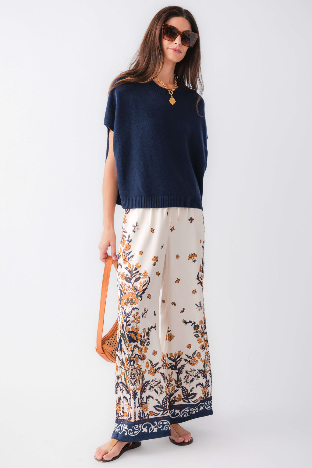 Ivory satin wide-leg pants, navy floral border along the cuffs